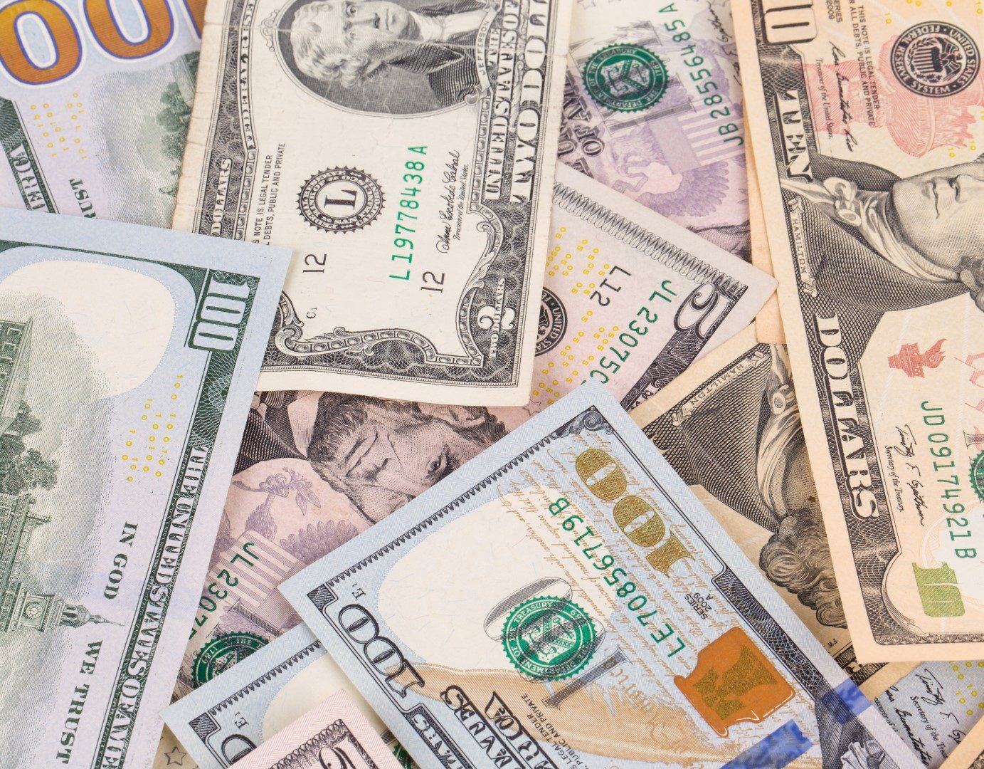 Assorted dollar bills representing asset recovery services in Arkansas