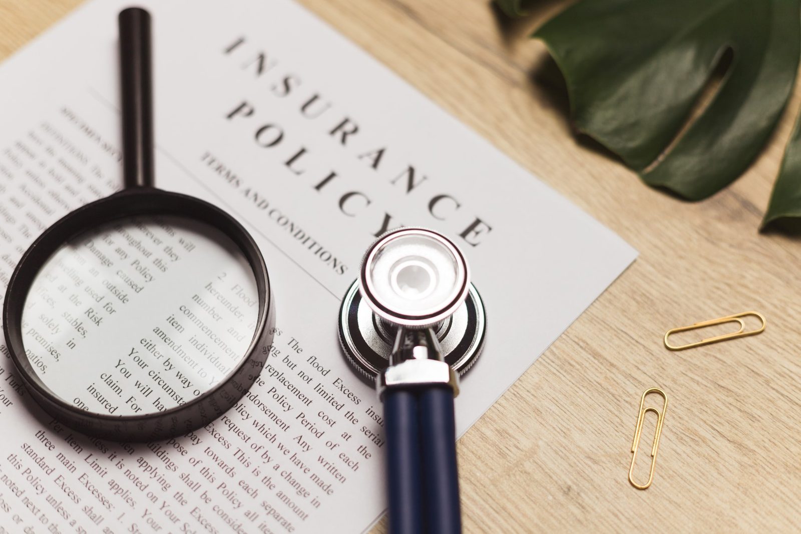 A stethoscope resting on a medical record and health insurance claim for insurance investigations