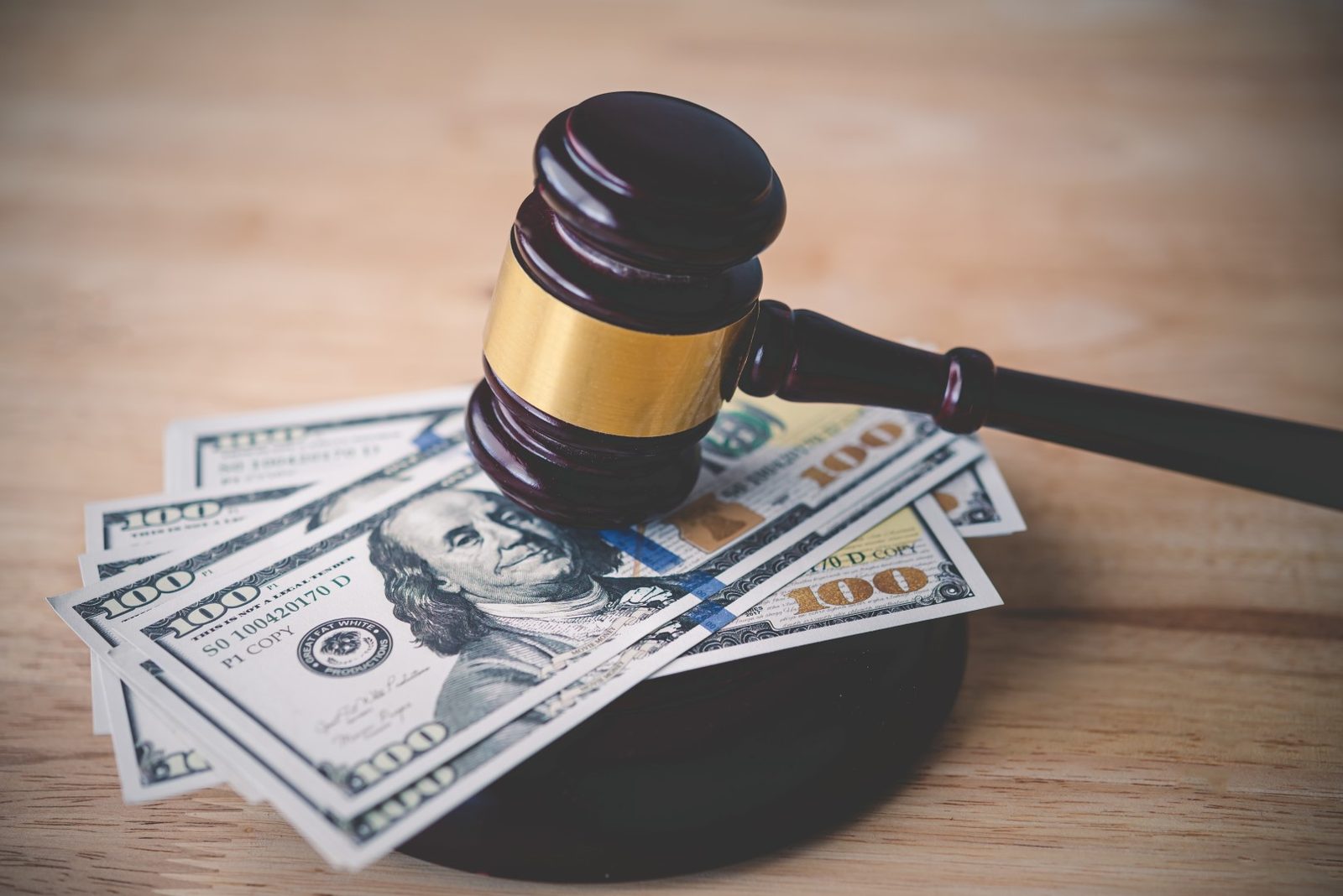 A judge gavel resting beside dollar bills, representing judgment enforcement in Little Rock